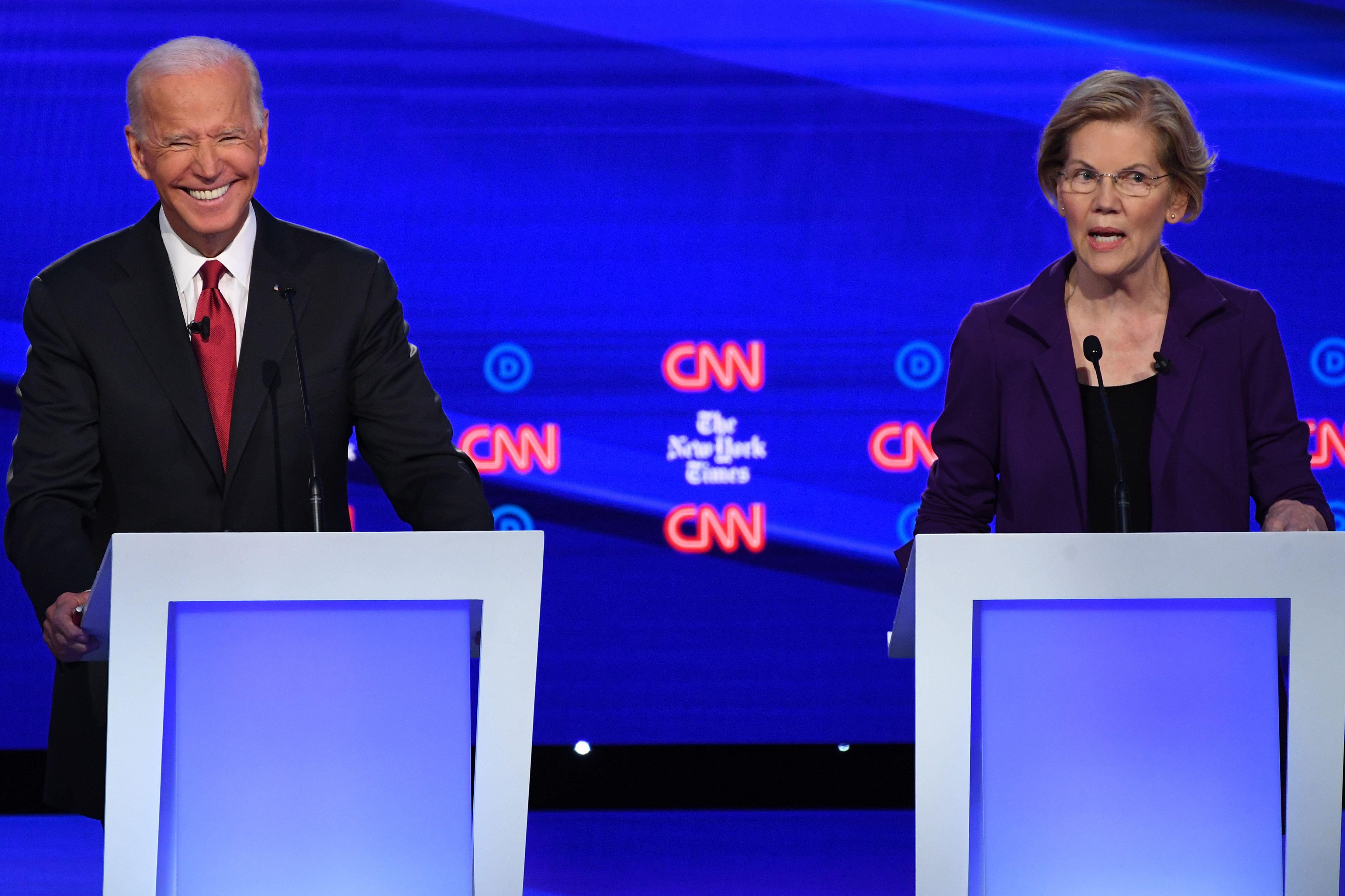 Elizabeth Warren speaks as Joe Biden gestures.