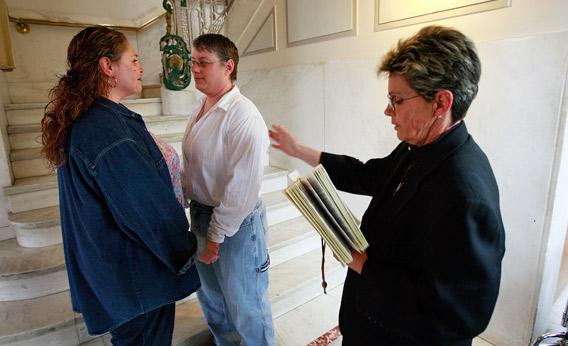 Amy Klein-Matheny (L) and her wife Jennifer are married by Rev. Peg Esperanza (R) near a stairway in the Polk County Administration Building April 27, 2009 in Des Moines, Iowa.