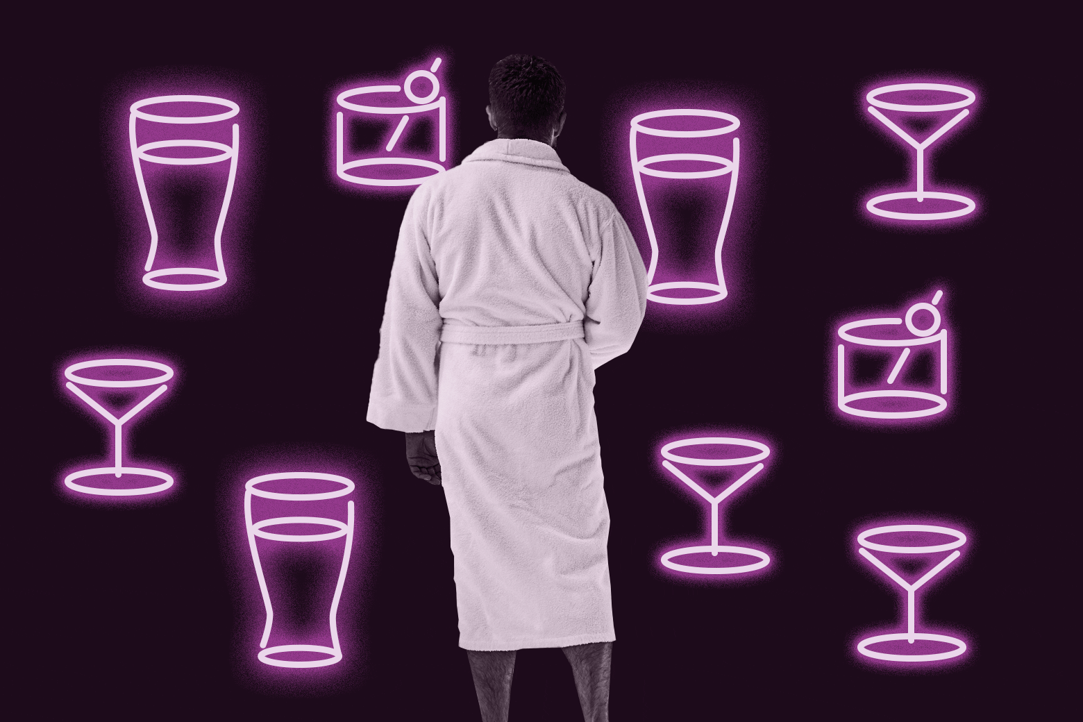 A man in a bathrobe with an assortment of neon glassware around him.