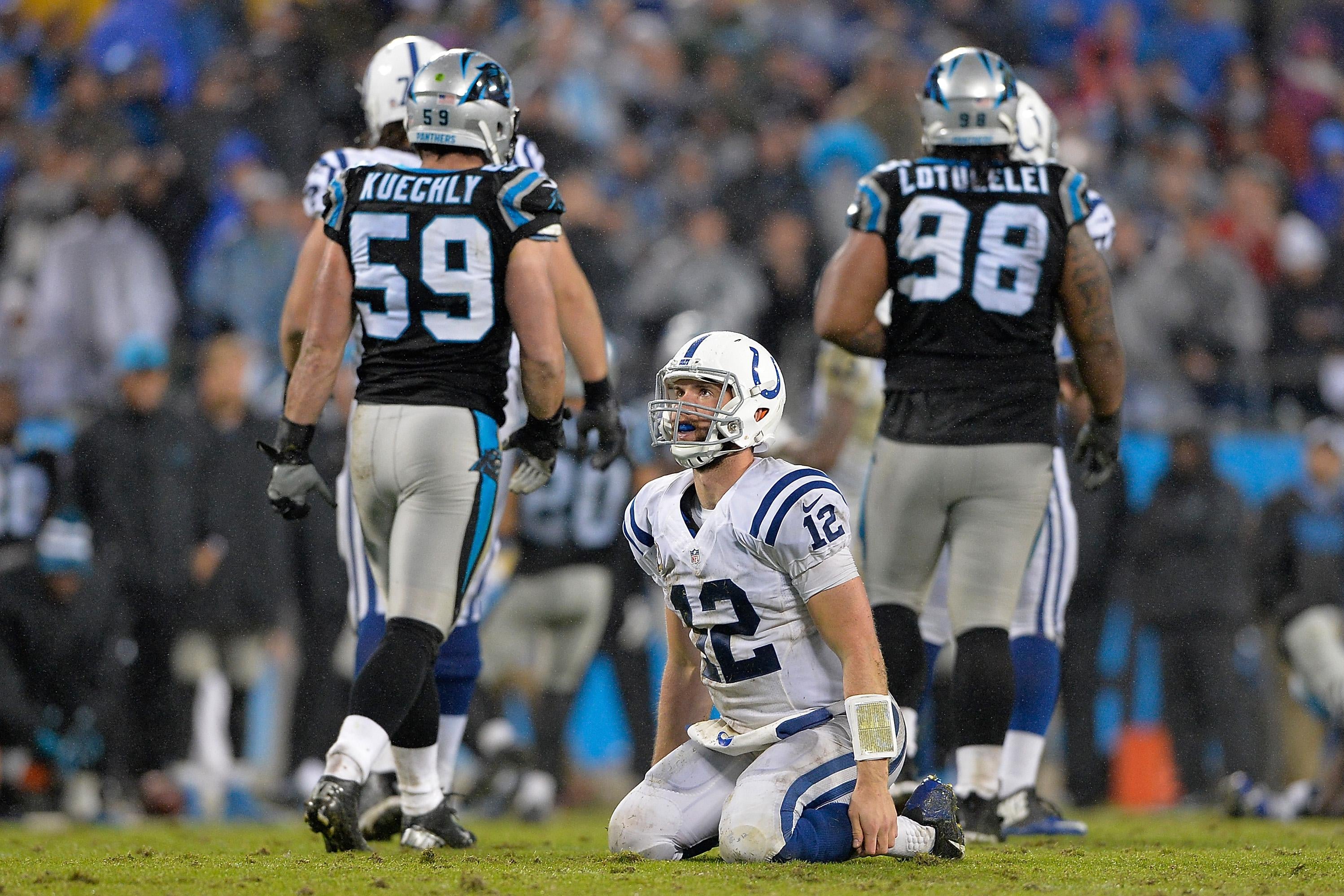 Andrew Luck sits on the ground in 2015.