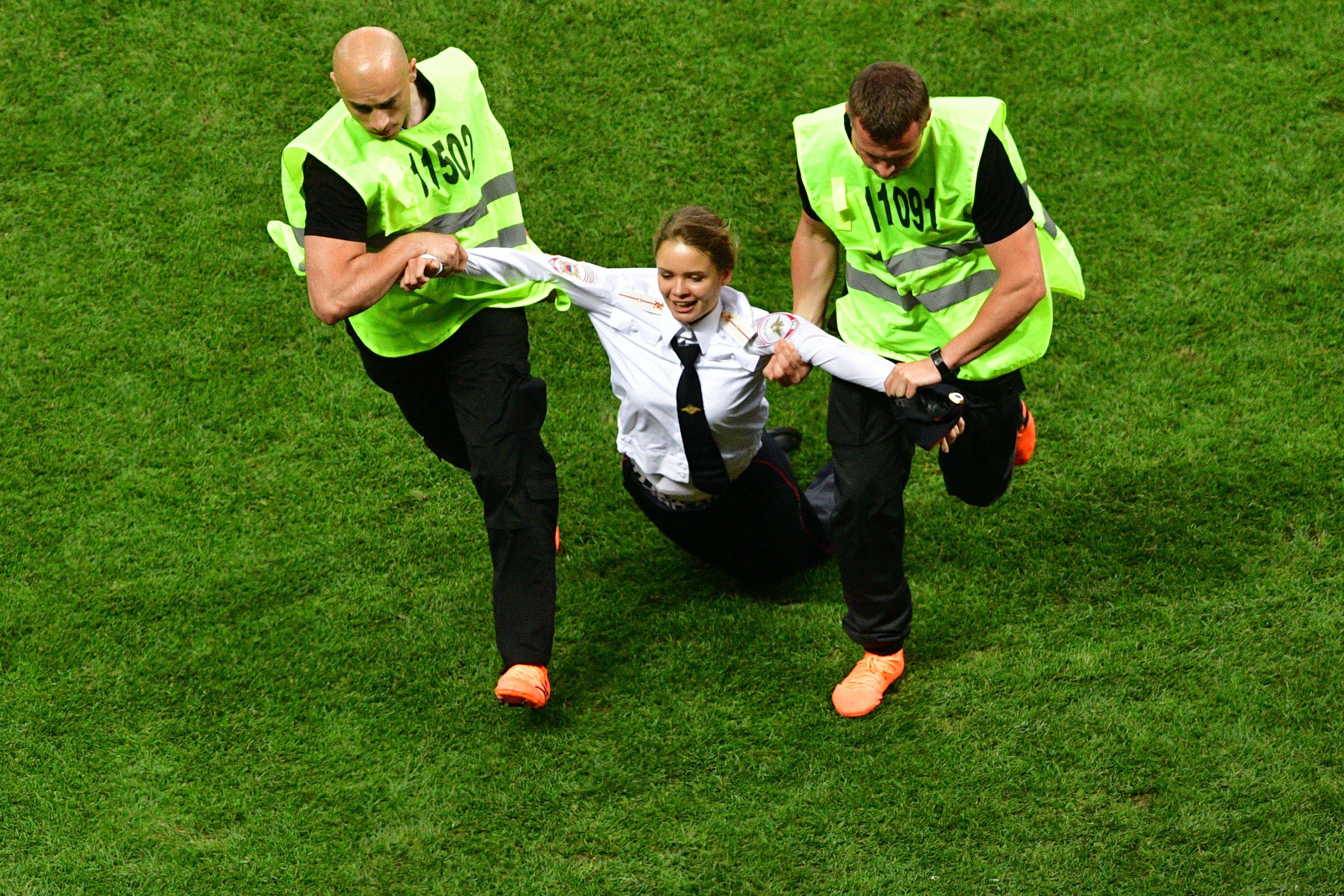 Stewards remove a pitch invader during the Russia 2018 World Cup final football match between France and Croatia at the Luzhniki Stadium in Moscow on July 15, 2018. (Photo by Mladen ANTONOV / AFP) / RESTRICTED TO EDITORIAL USE - NO MOBILE PUSH ALERTS/DOWNLOADS        (Photo credit should read MLADEN ANTONOV/AFP/Getty Images)