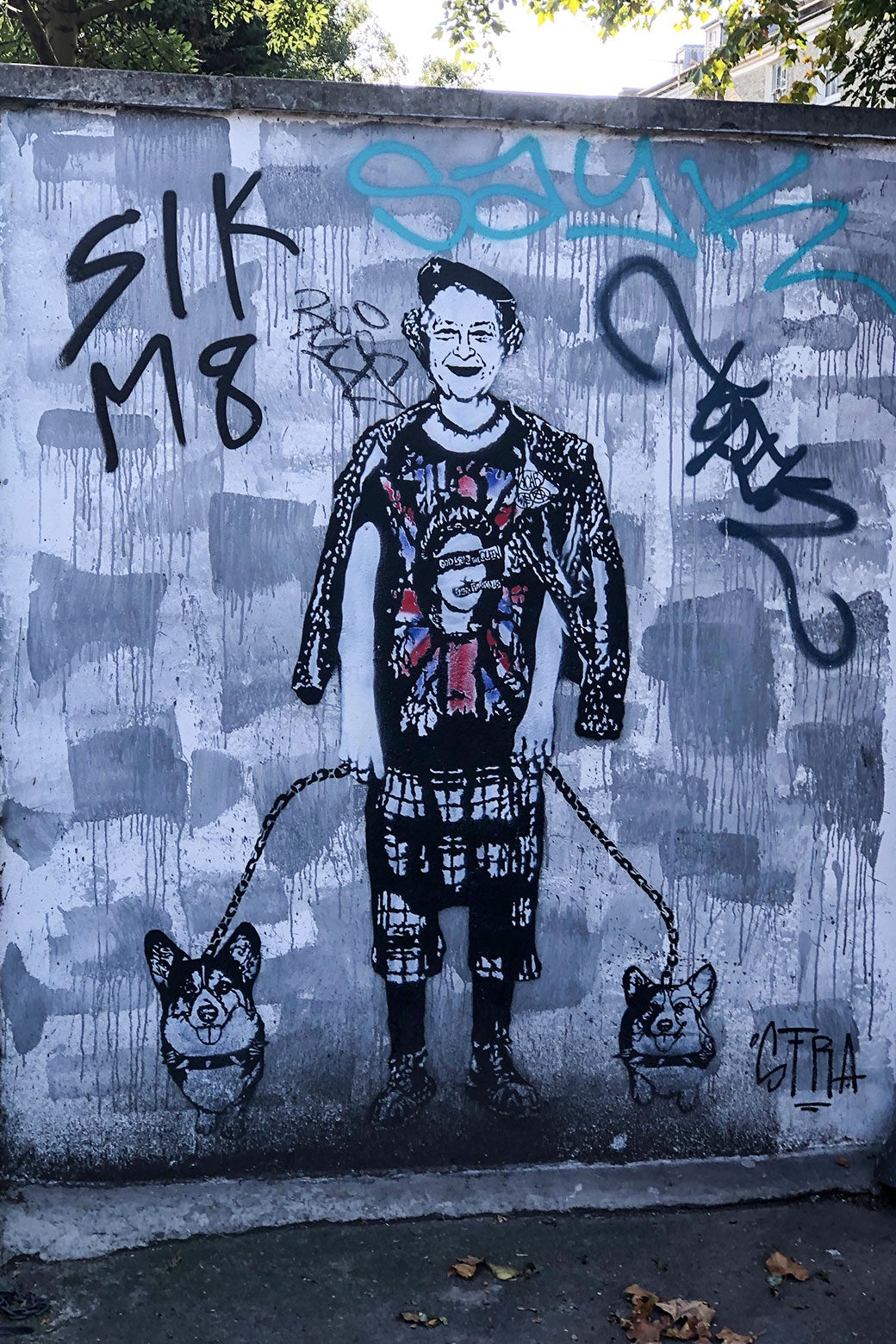 Graffiti of Queen Elizabeth with two corgis. 
