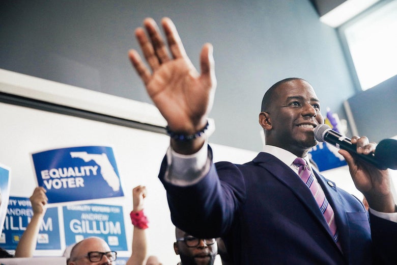 Andrew Gillum speaks into a microphone at a campaign rally.