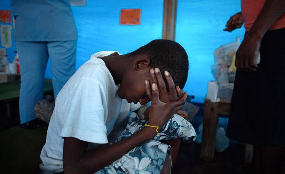 Fifteen-year-old cholera patient Jonas Florvil sits on a cot in a ward at a Samaritan's Purse cholera treatment center in the Cite Soleil neighborhood of Port-au-Prince, Haiti, Jan. 8, 2011.