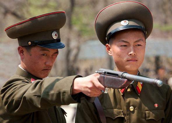 Soldiers at a Pyongyang fun fair in 2010. The targets read: "Kill the US imperialists." 