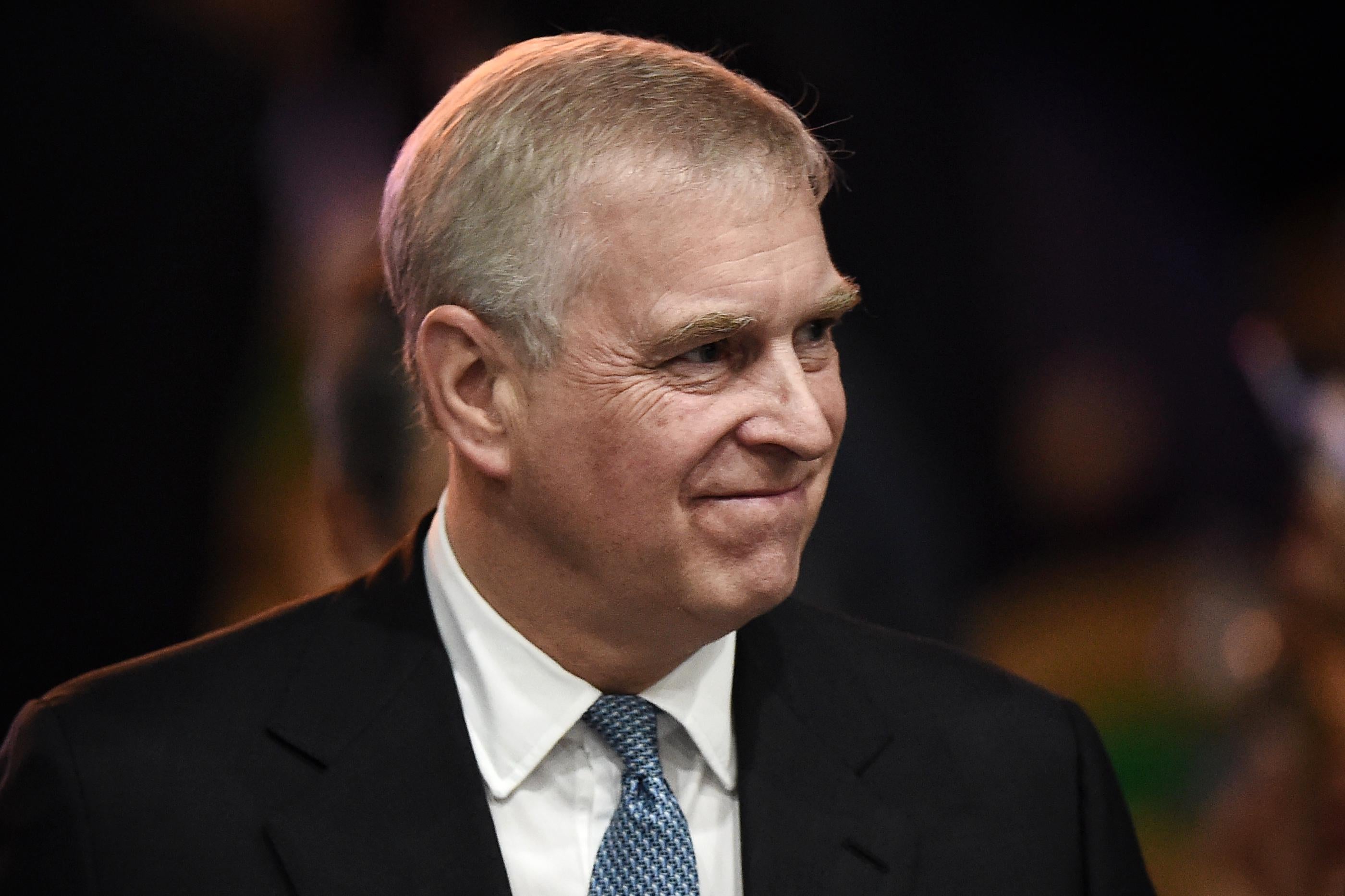 Prince Andrew offers a closed-mouth smile.