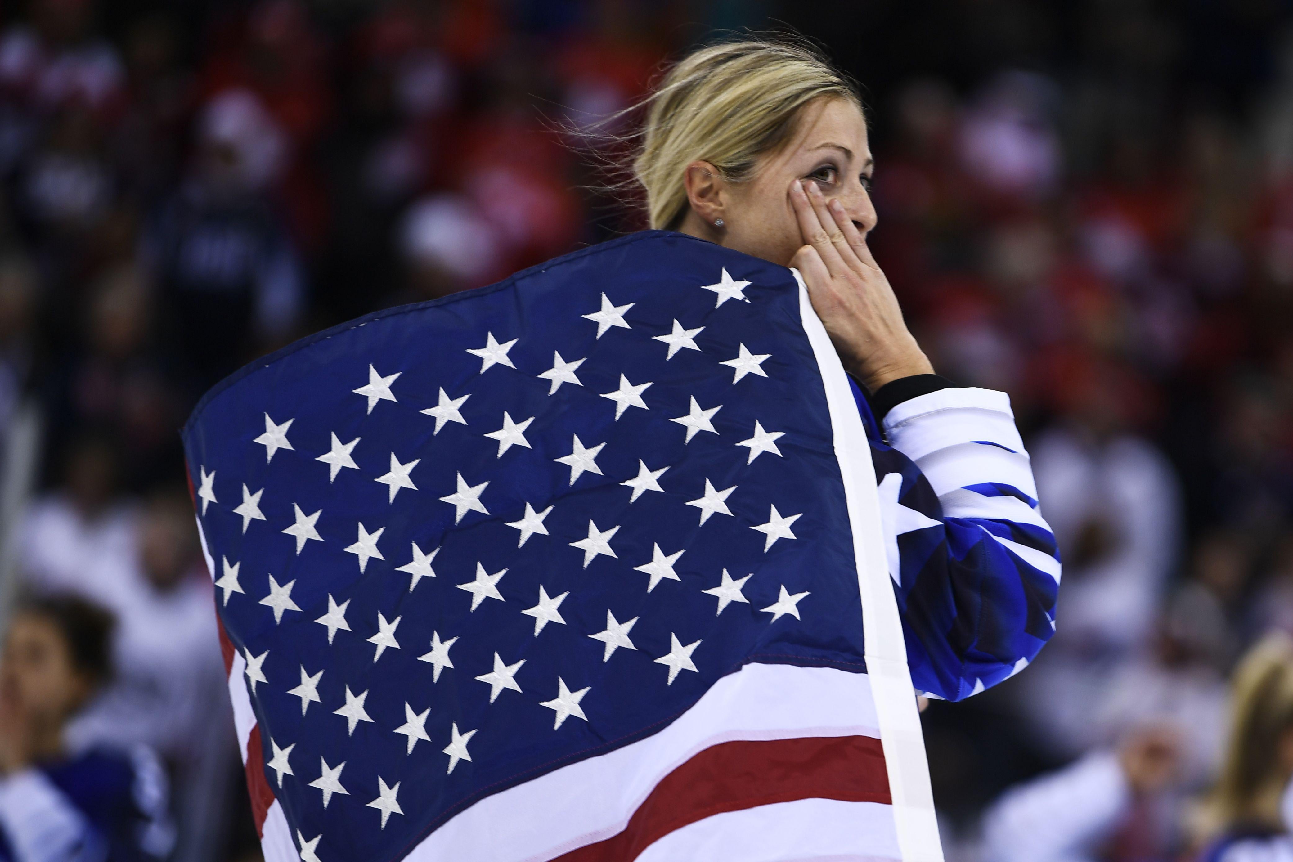 USA's Gigi Marvin holds the US flag after her team won the women's gold medal ice hockey match between the US and Canada during the Pyeongchang 2018 Winter Olympic Games at the Gangneung Hockey Centre in Gangneung on February 22, 2018. / AFP PHOTO / Brendan Smialowski (Photo credit should read BRENDAN SMIALOWSKI/AFP/Getty Images)