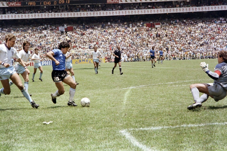Maradona runs past English defender Terry Butcher on his way to dribbling goalkeeper Peter Shilton, already on the ground, and scoring