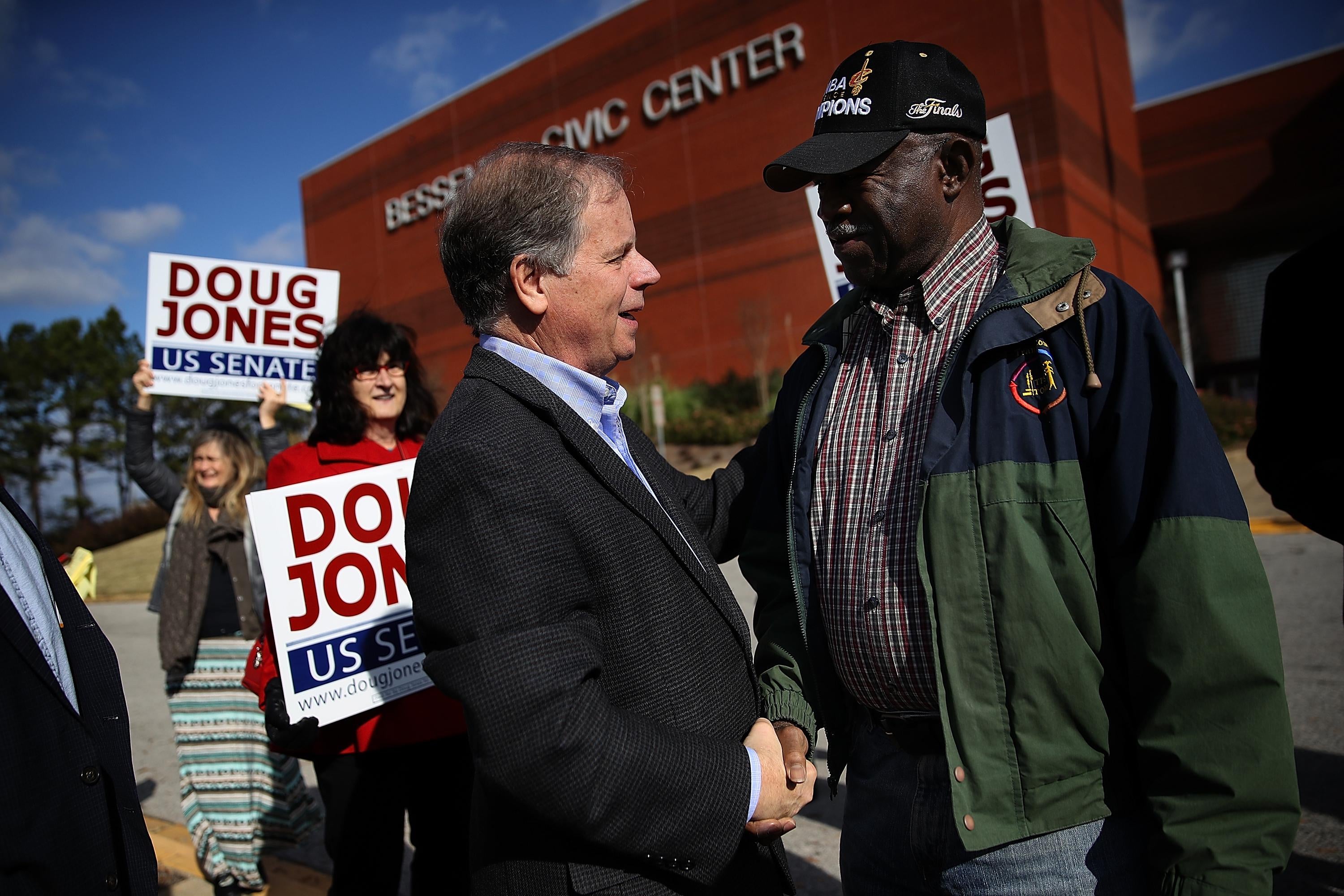 BESSEMER, AL - DECEMBER 12:  Democratic Senatorial candidate Doug Jones (L) greets voters outside of a polling station at the Bessemer Civic Center on December 12, 2017 in Bessemer, Alabama. Doug Jones is facing off against Republican Roy Moore in a special election for U.S. Senate.  (Photo by Justin Sullivan/Getty Images)
