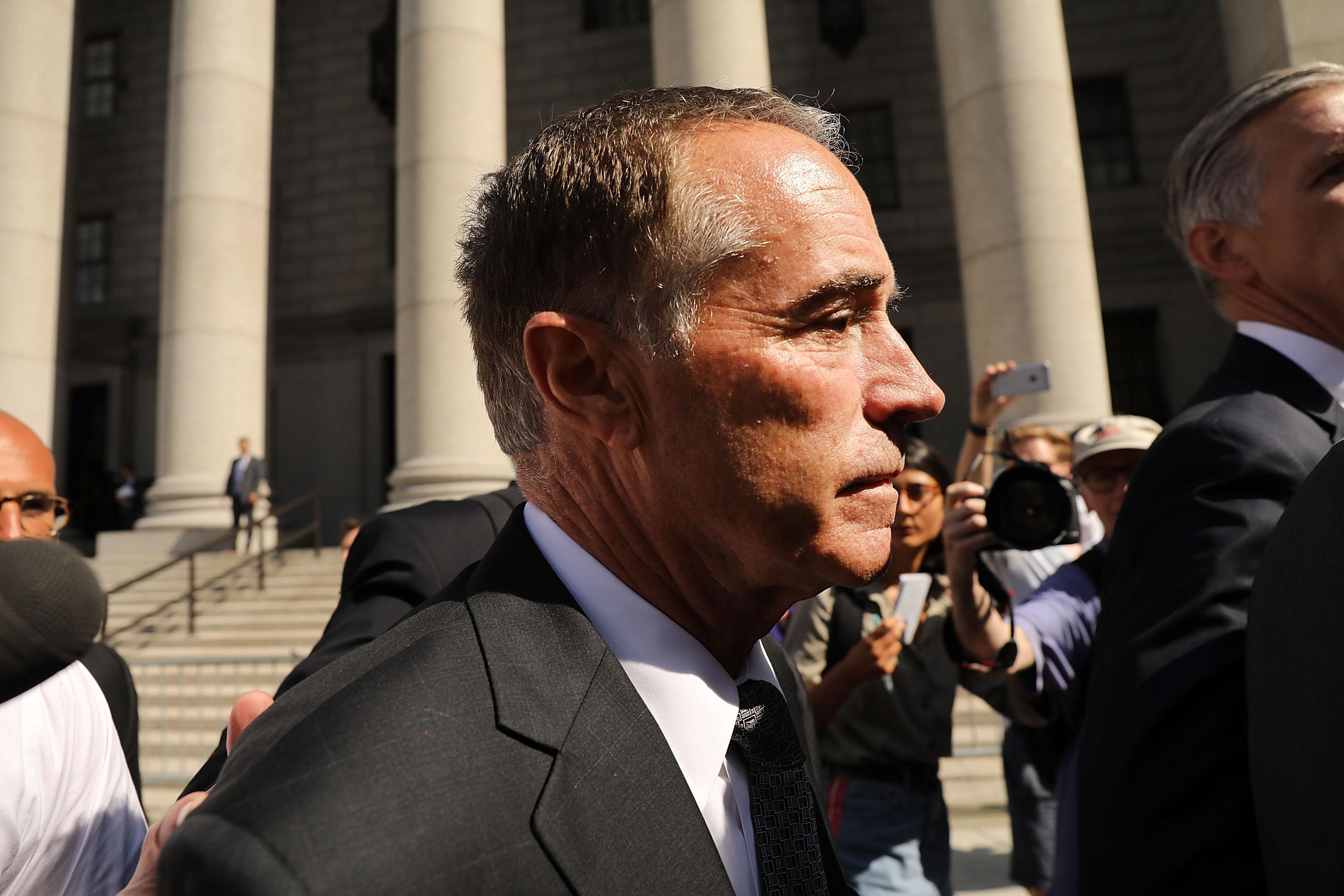 Chris Collins outside a courthouse, surrounded by cameras