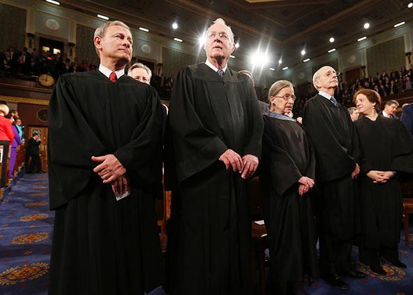 U.S. Supreme Court Chief Justice John Roberts (L) stands with fellow Justices Anthony Kennedy (2nd from L), Ruth Bader Ginsburg, Stephen Breyer and Elena Kagan.