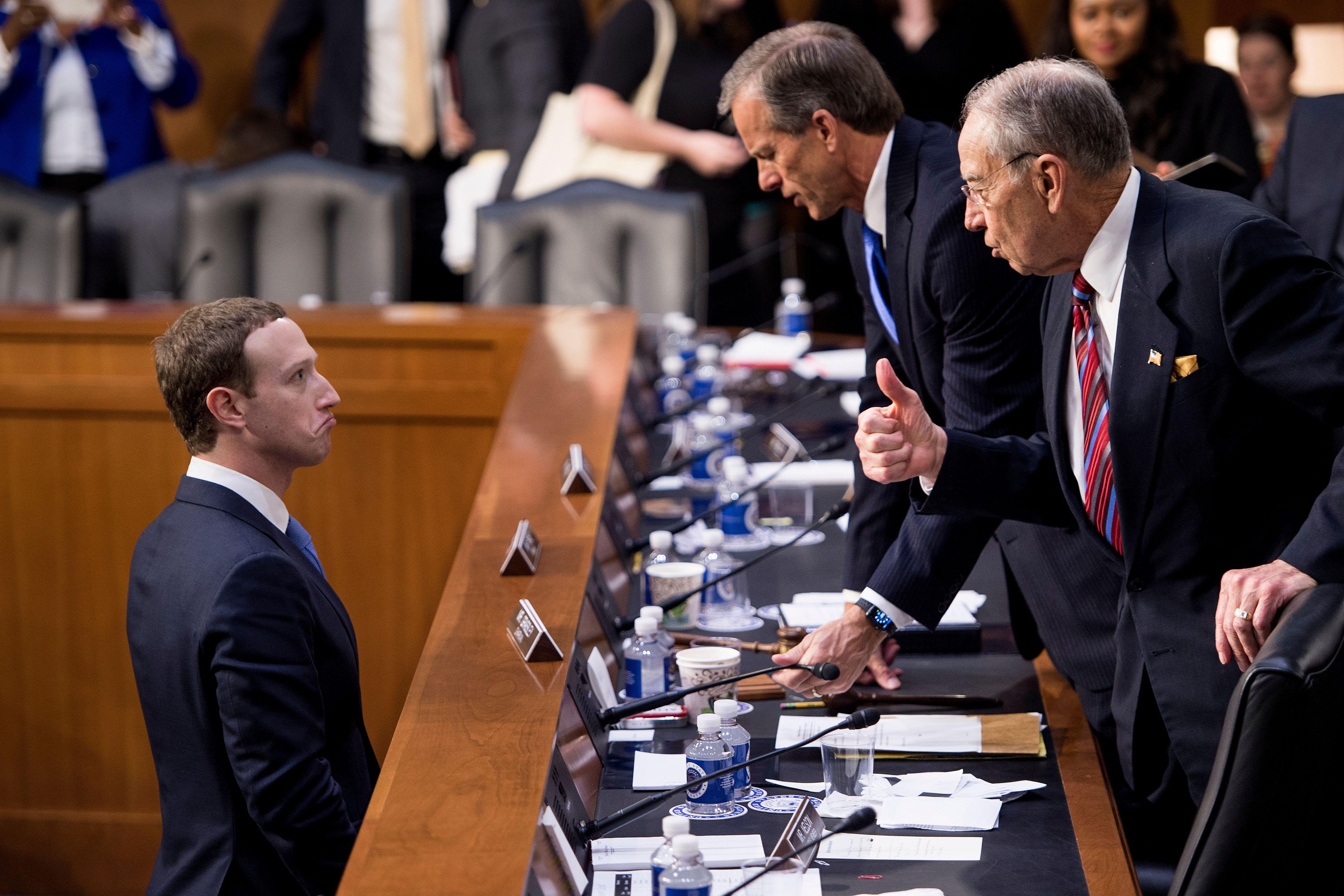 Facebook CEO Mark Zuckerberg (L) speaks with Senator John Thune (C), R-SD, and Senator Chuck Grassley (R), R-IA following a joint hearing of the Senate Commerce, Science and Transportation Committee and Senate Judiciary Committee on Capitol Hill April 10, 2018 in Washington, DC.
Facebook chief Mark Zuckerberg took personal responsibility Tuesday for the leak of data on tens of millions of its users, while warning of an 'arms race' against Russian disinformation during a high stakes face-to-face with US lawmakers. / AFP PHOTO / Brendan Smialowski        (Photo credit should read BRENDAN SMIALOWSKI/AFP/Getty Images)