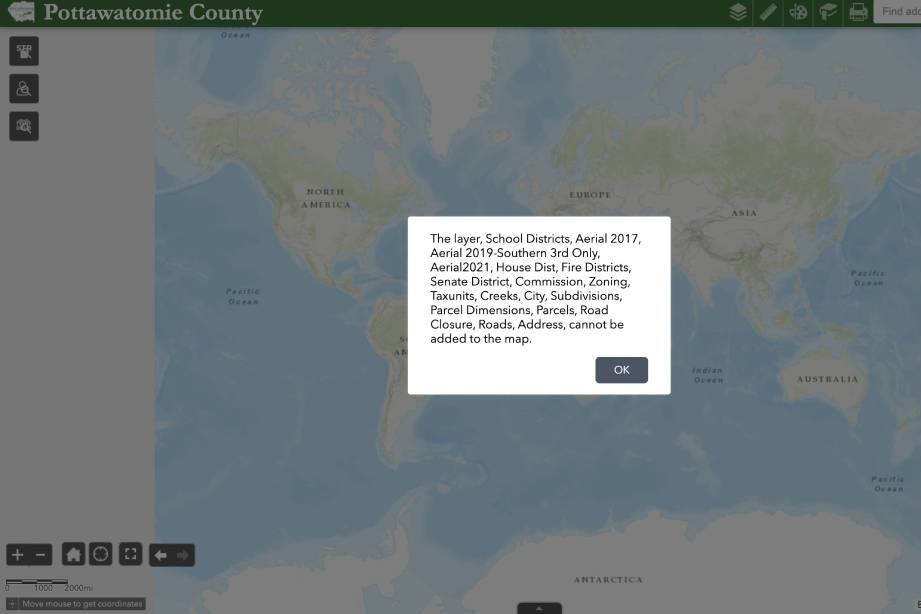 An error message overlaid on a map of the world on the Pottawatomie County website. 