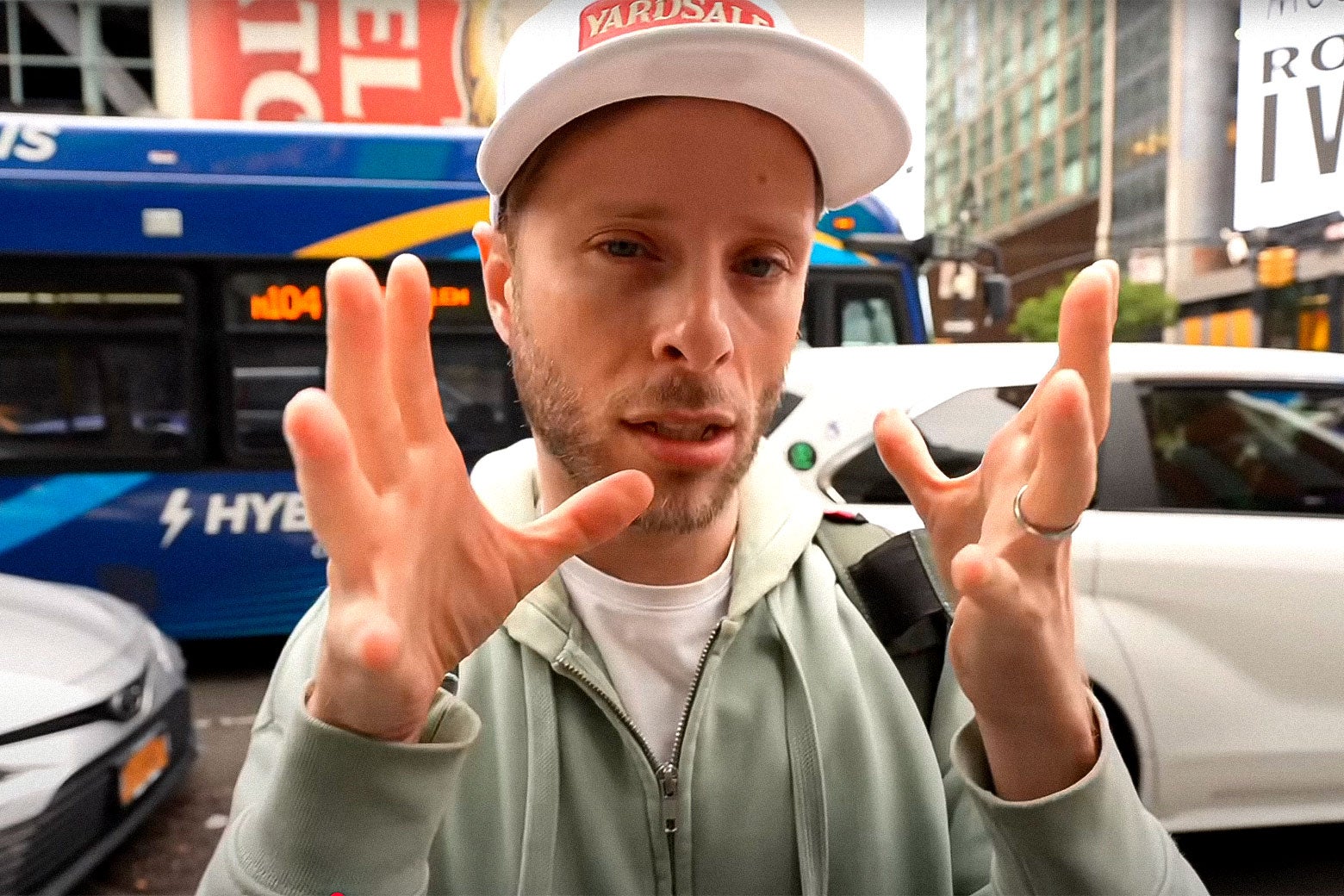 Cash Jordan, a White man, talking to his camera on the streets of New York City.