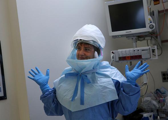 A member of Bellevue Hospital’s staff wears protective clothing during a demonstration on how the hospital would receive a suspected Ebola patient on Oct. 8, 2014, in New York City