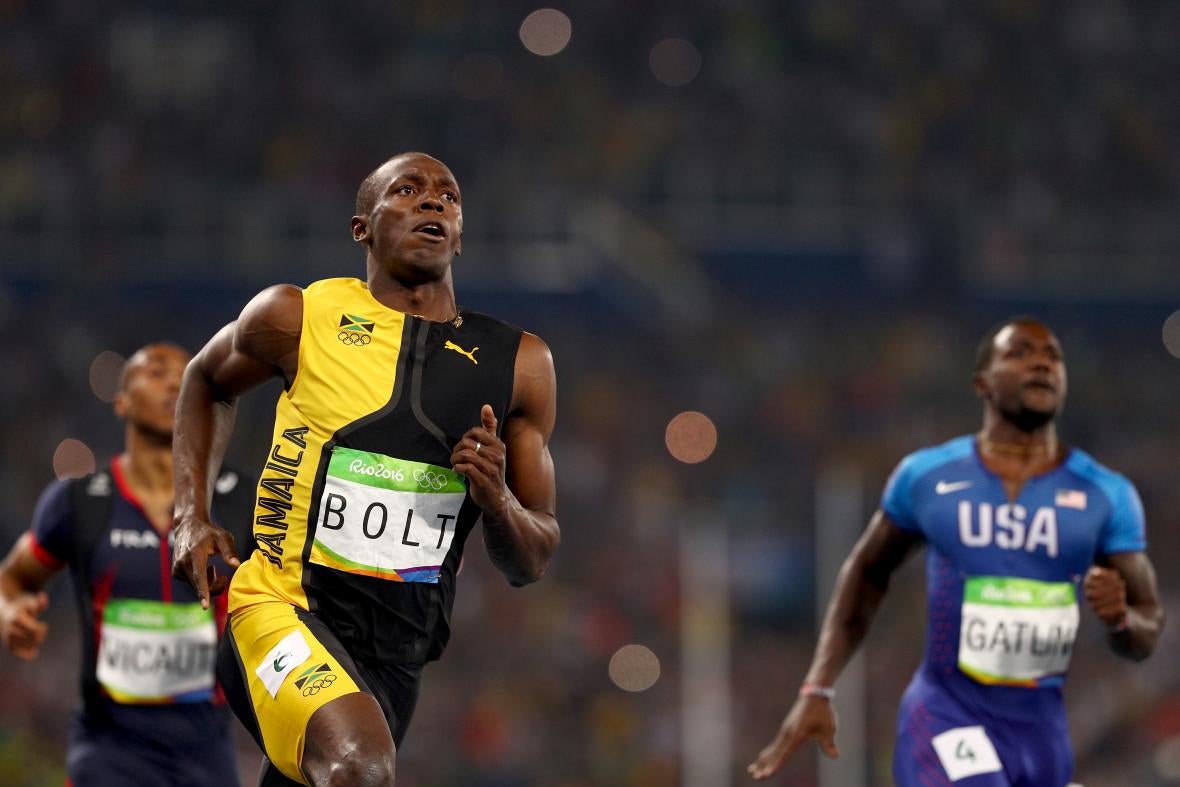 Bold and Gatlin running side by side, Bolt finishing ahead