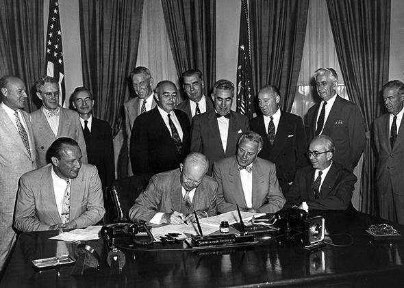 President Dwight D. Eisenhower signs a bill into law.