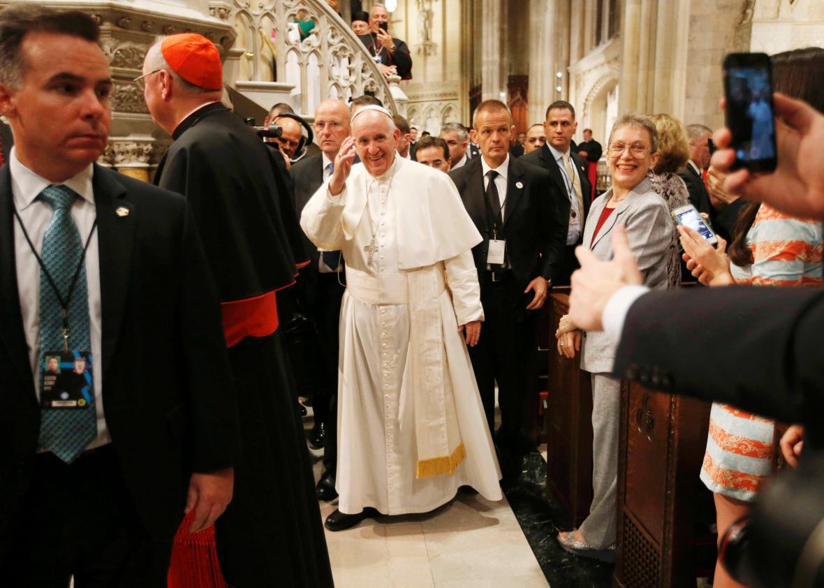 Pope Francis waves as he departs after presiding over evening prayers at St. Patrick's Cathedral in New York, September 24, 2015. 