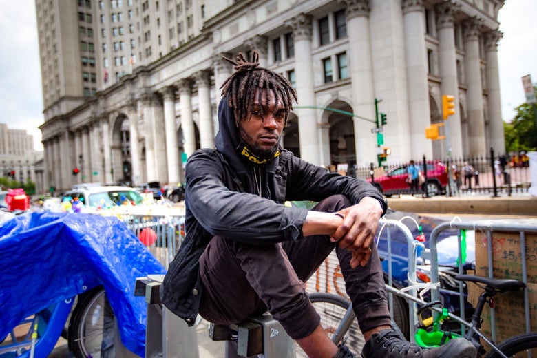 Jawanza James Williams sits on a Citi Bike dock