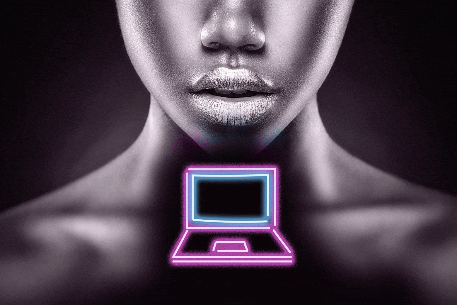 Close up of a woman's lips with a laptop in front of her.