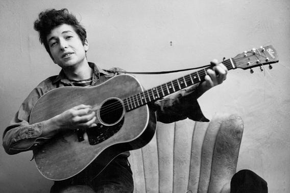 Bob Dylan poses for a portrait with his Gibson acoustic guitar in September 1961 in New York City