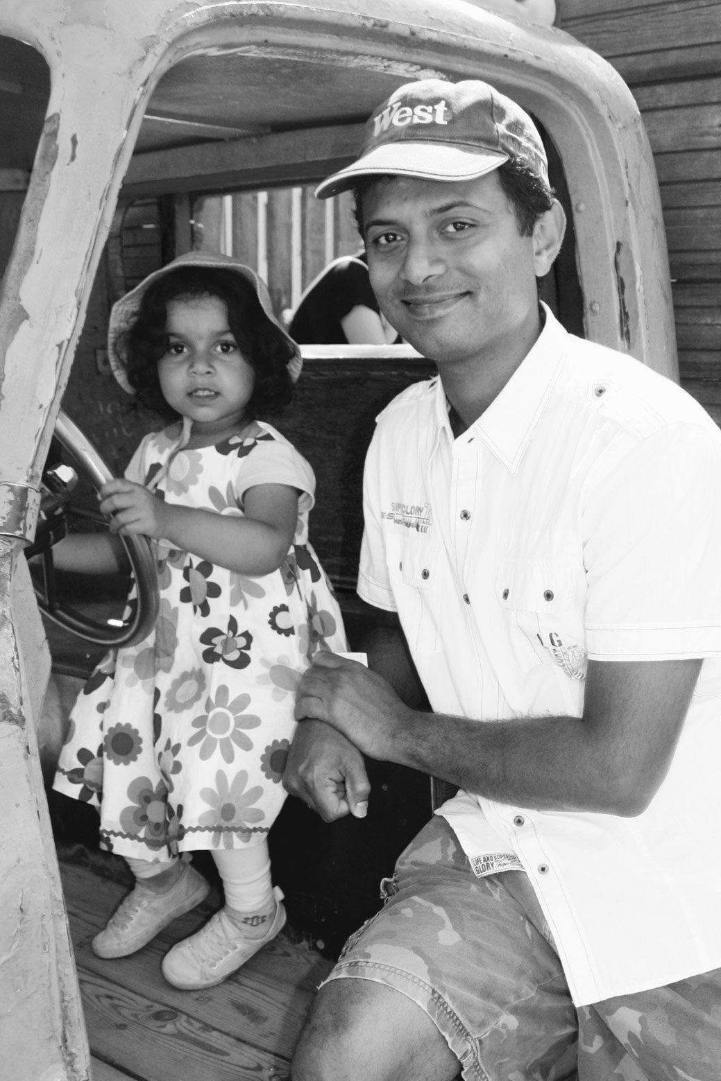 This dad and daughter kindly paused their game of make-believe to pose for a photo at a bustling urban playground.