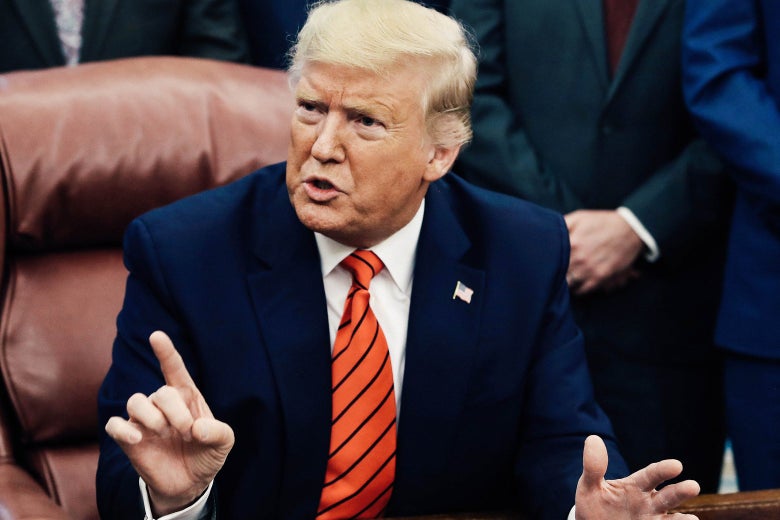 Donald Trump speaks while pointing a finger to the ceiling.