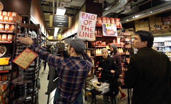 People try to get through the aisles at Whole Foods Market in midtown in New York on Sunday, as residents do last minute food shopping in preparation for Hurricane Sandy.