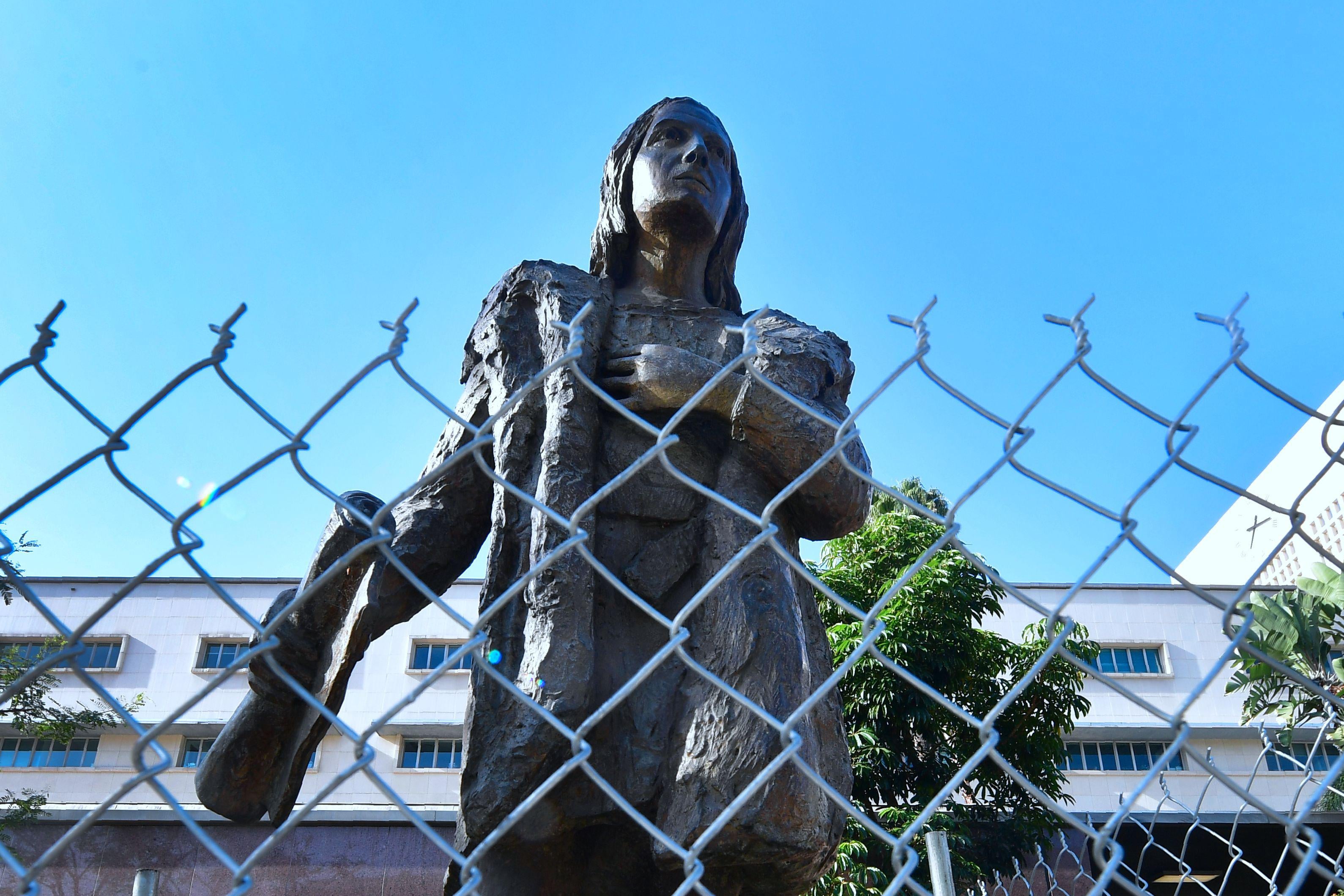 A statue of Christopher Columbus at a downtown Los Angeles park is surrounded by a chain-link fence on October 9, 2017 in Los Angeles, California. 