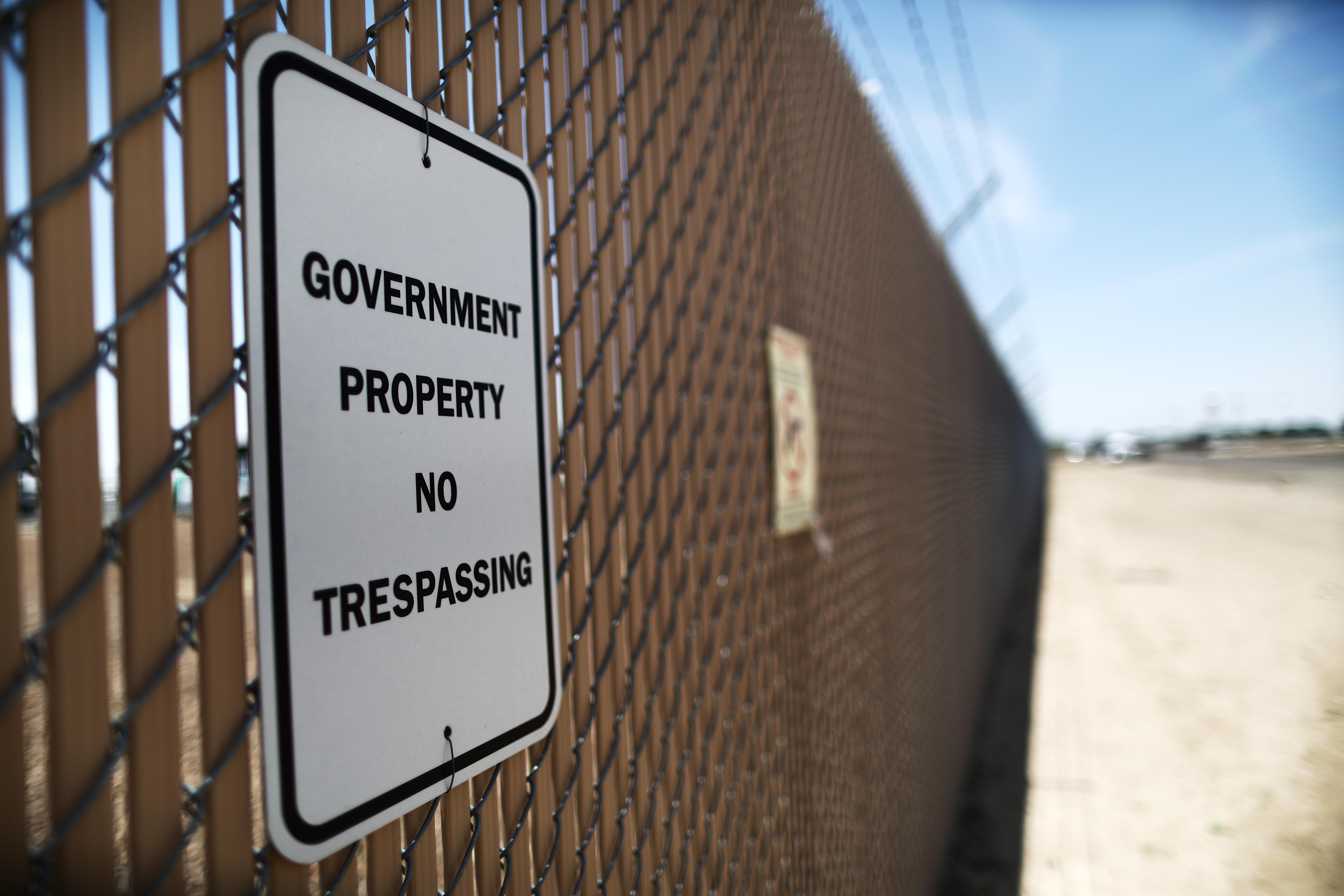 A sign reading "government property, no trespassing" is posted at the U.S. Border Patrol station on June 26, 2019 in Clint, Texas. 