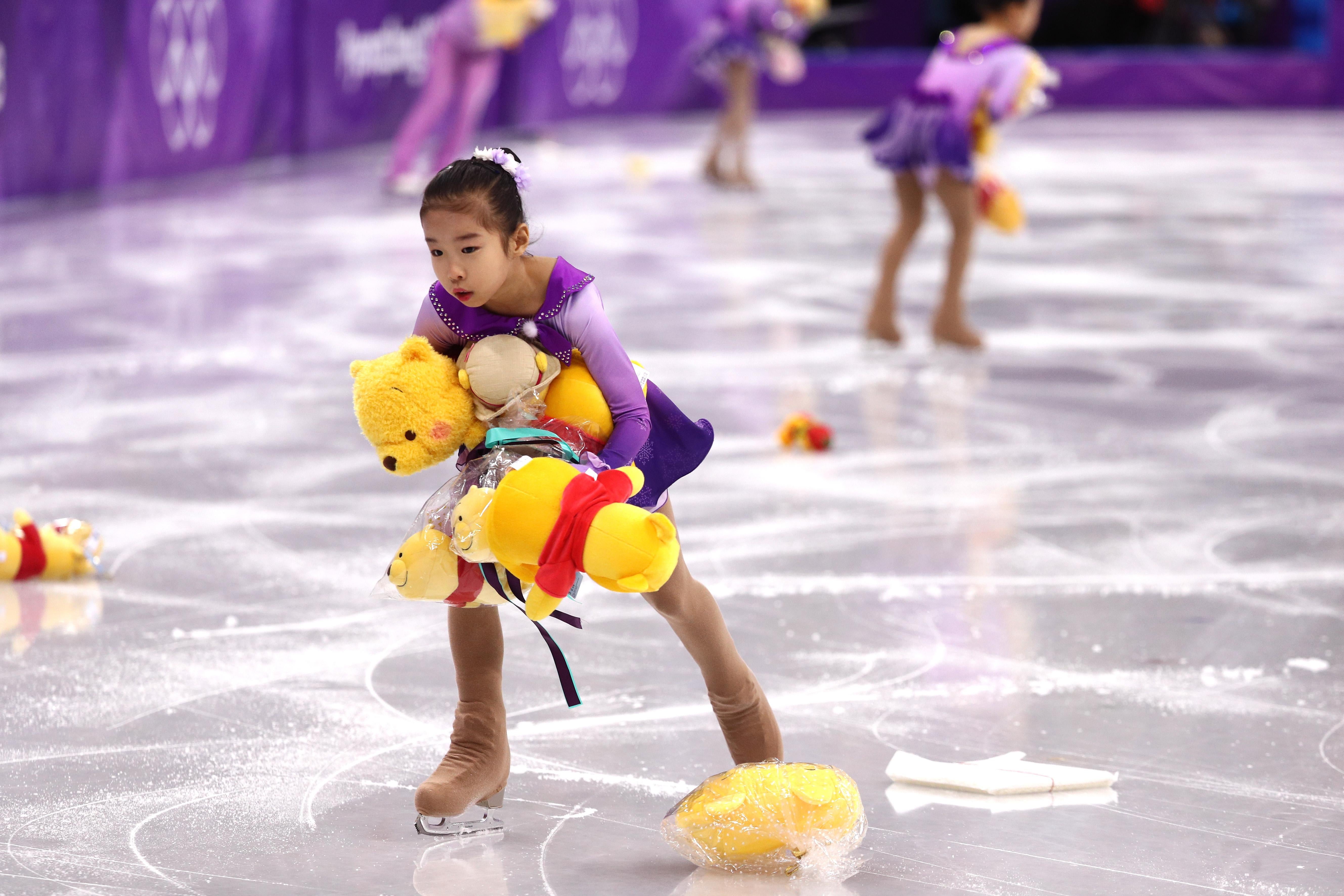 GANGNEUNG, SOUTH KOREA - FEBRUARY 16:  Skaters pick up gifts thrown to the ice for Yuzuru Hanyu of Japan during the Men's Single Skating Short Program at Gangneung Ice Arena on February 16, 2018 in Gangneung, South Korea.  (Photo by Maddie Meyer/Getty Images)