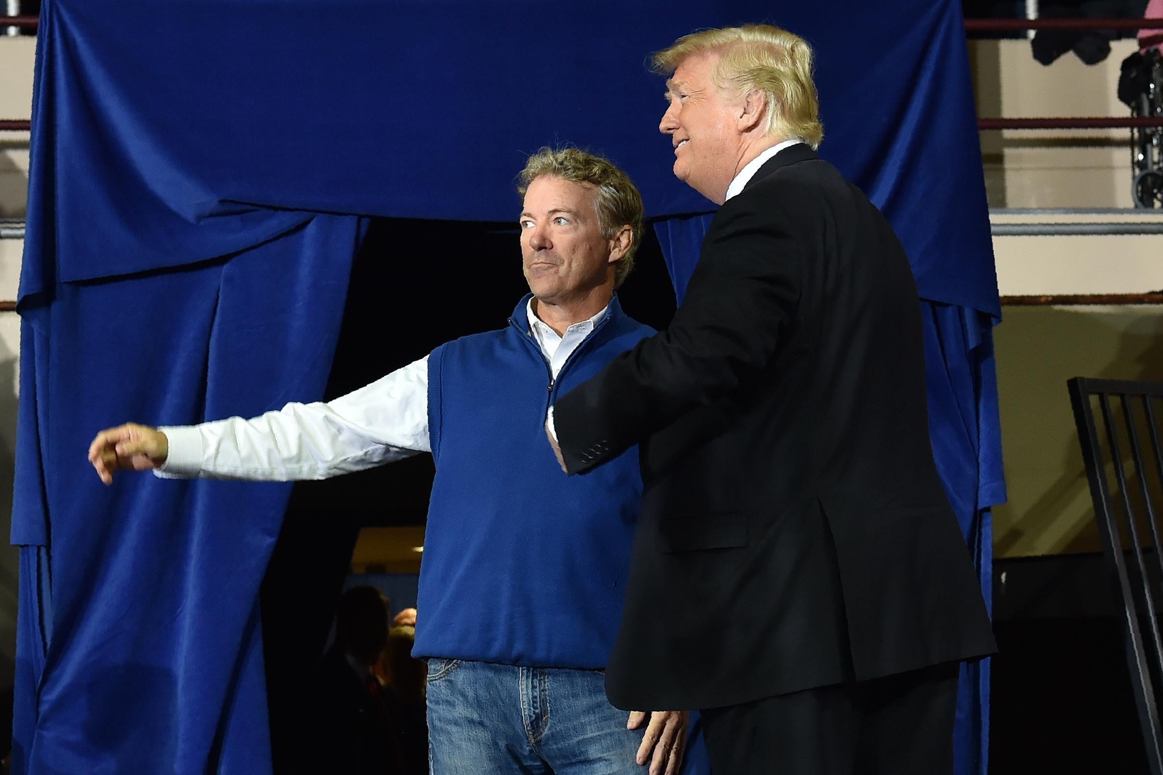 President Donald Trump speaks to Senator Rand Paul during a rally at the Eastern Kentucky University, in Richmond, Kentucky, on October 13, 2018. 