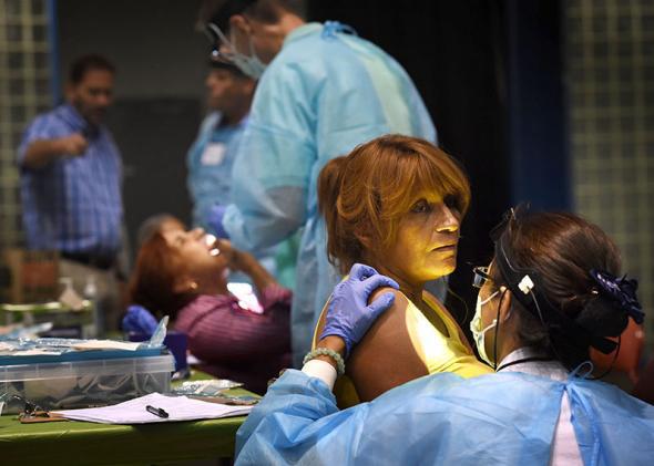 People receive dental care during a free healthcare clinic.