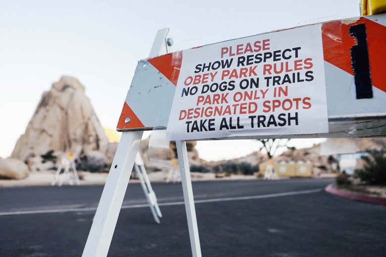 A sign placed by staff is posted on a temporary barricade at a closed campground at Joshua Tree National Park.