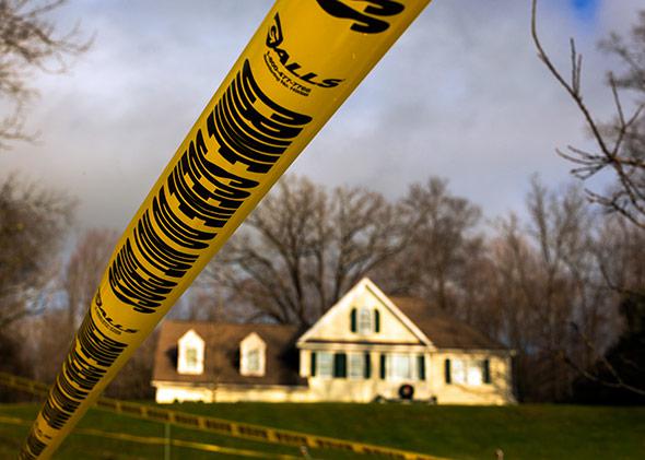 Crime scene tape remains outside Nancy Lanza's Sandy Hook Village home in Newtown, Connecticut December 18, 2012.
