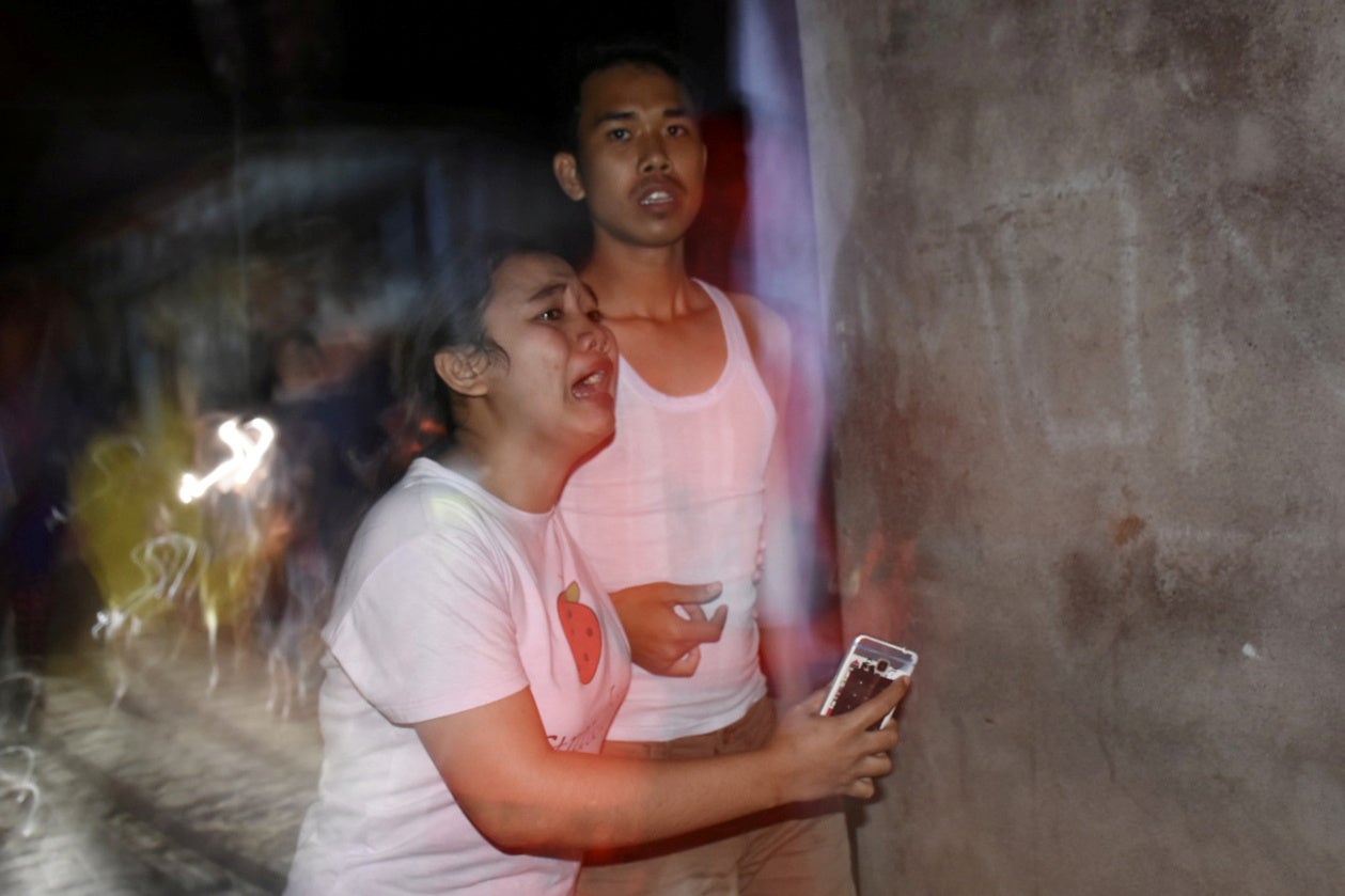 People react following an earthquake in Ampenan district, Mataram, Lombok, Indonesia on August 5, 2018.