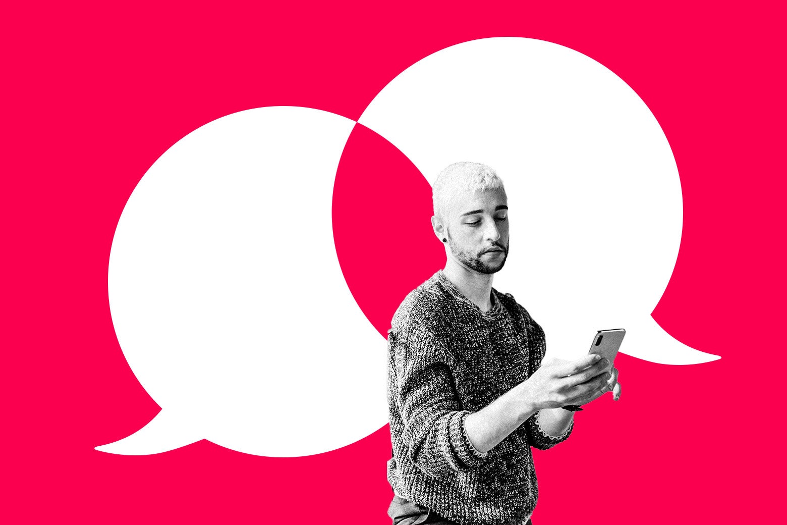 A man looks uncertainly at his phone.