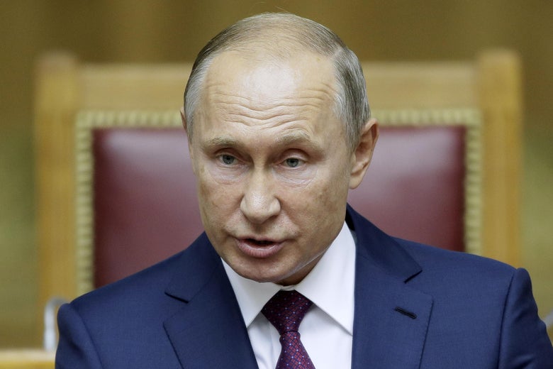Russian President Vladimir Putin speaks while wearing a suit
