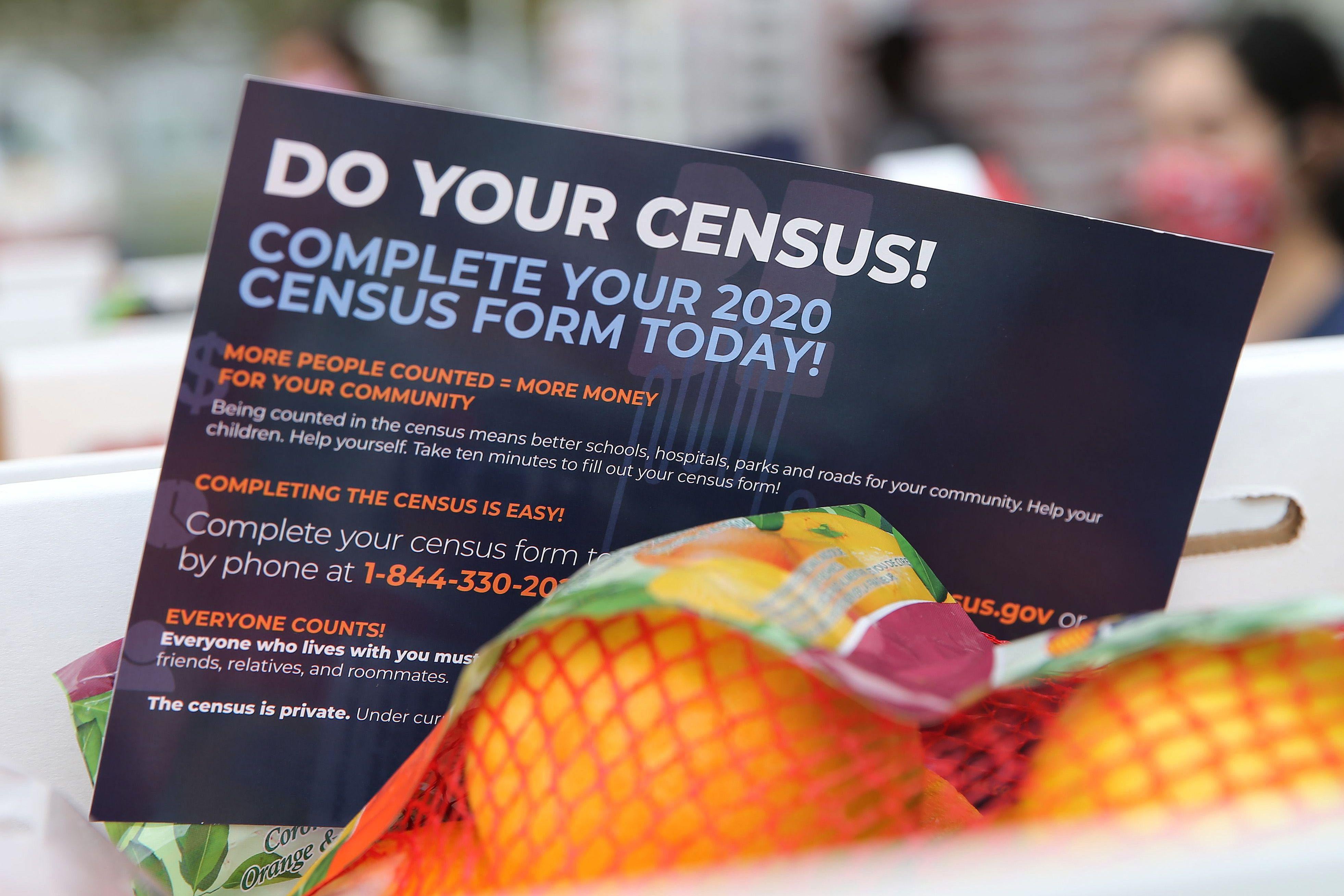 A pamphlet with 2020 census information is included in a box of food to be distributed by the Los Angeles Regional Food Bank to people facing economic or food insecurity amid the COVID-19 pandemic