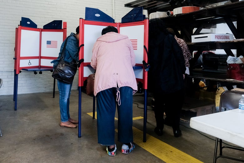 Voters huddled around voting booths to fill out their ballots