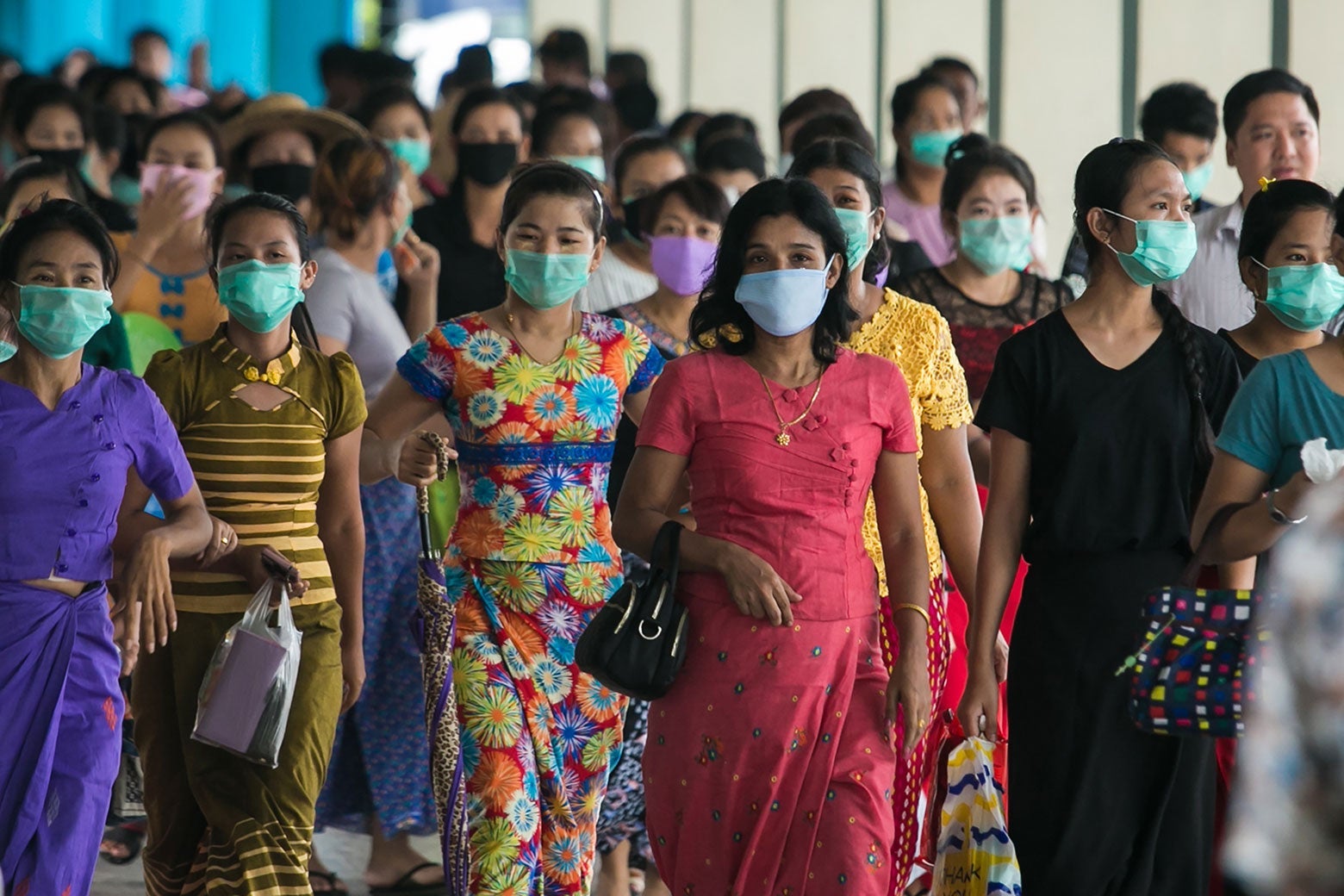 A crowd of women wearing protective masks