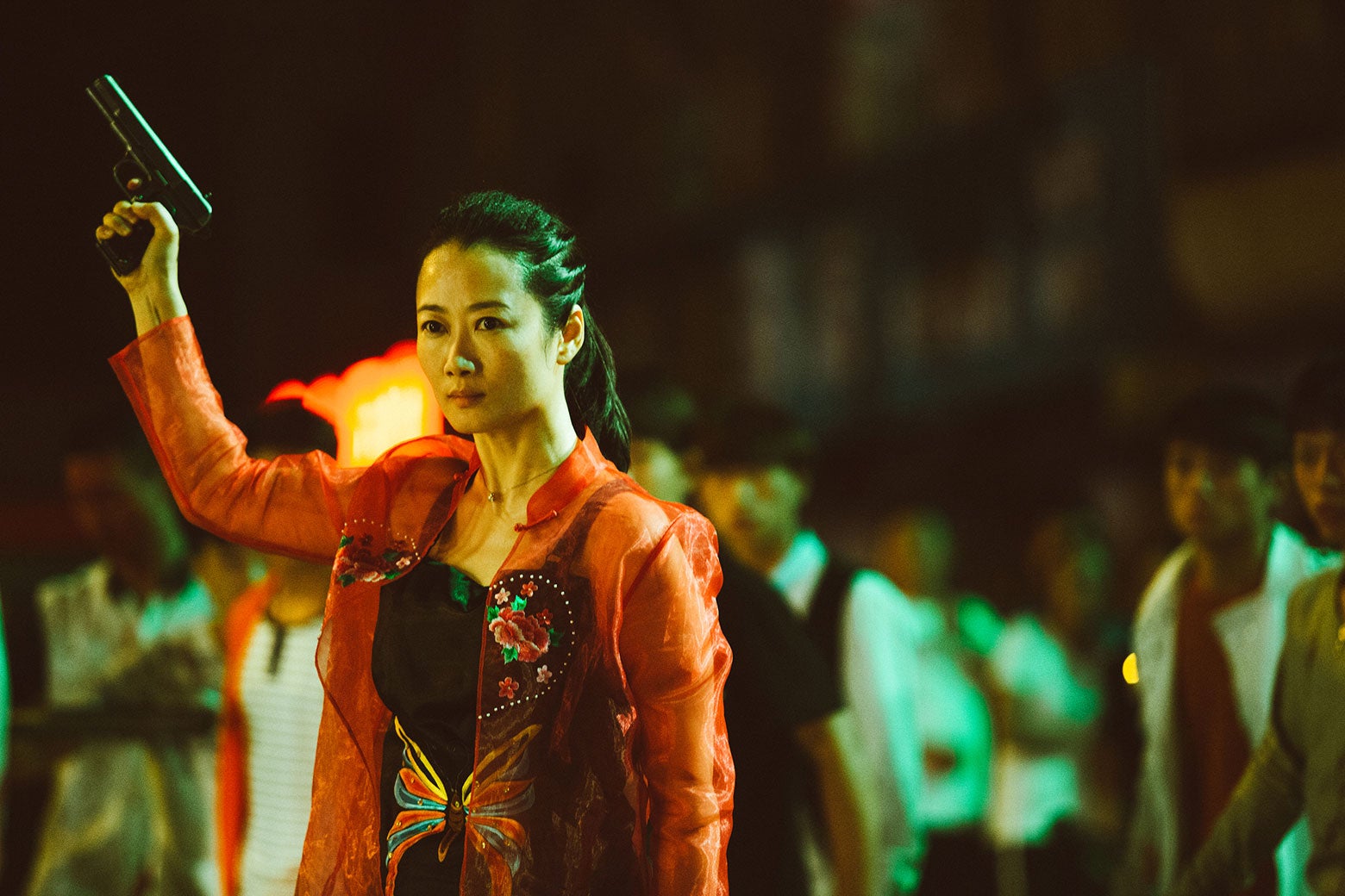 Qiao holding up a gun in Ash Is Purest White.