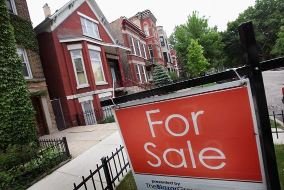 A 'For Sale' sign stands in front of a house on May 31, 2011 in Chicago, Illinois.