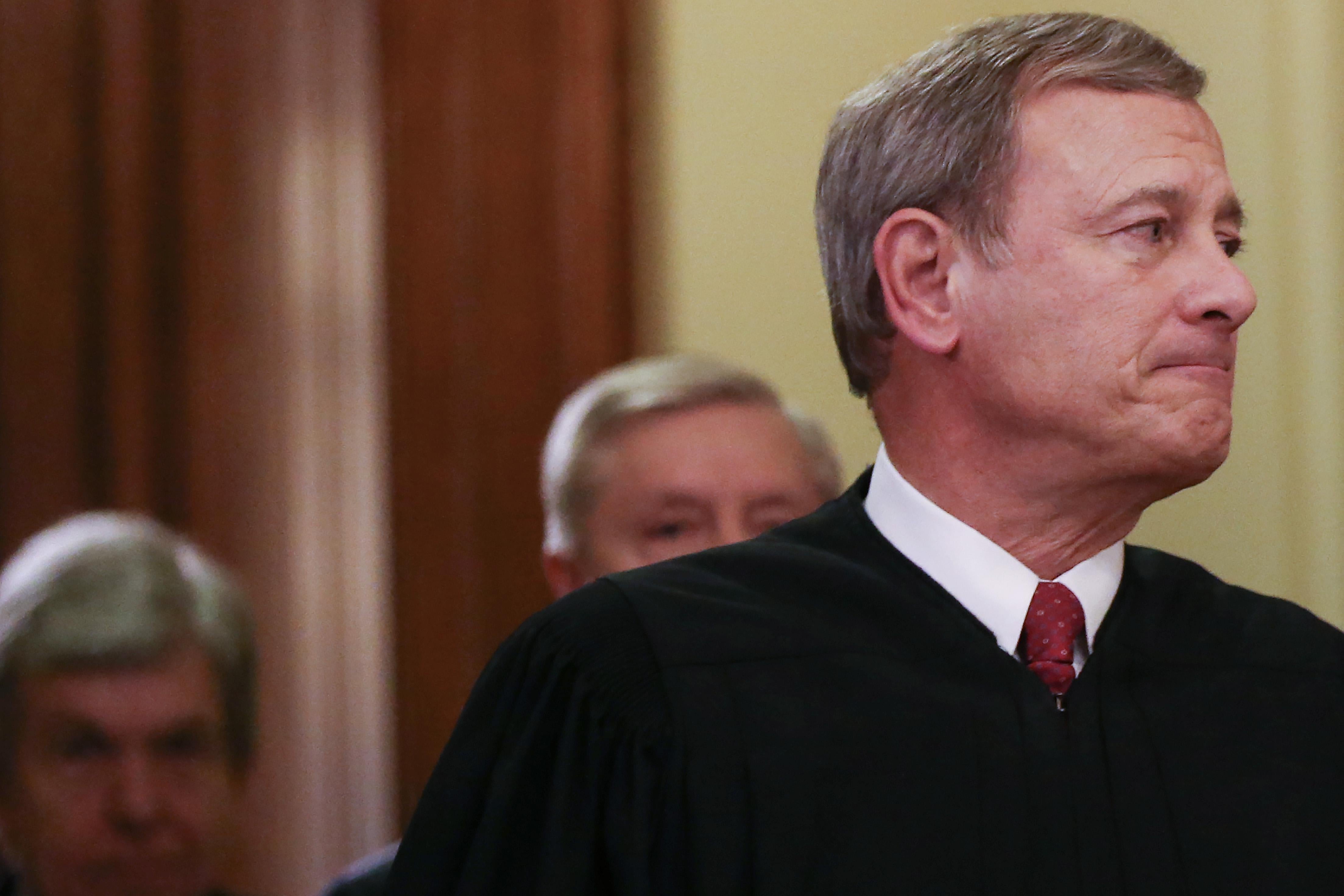 John Roberts, wearing his judicial robes, looks to the right.