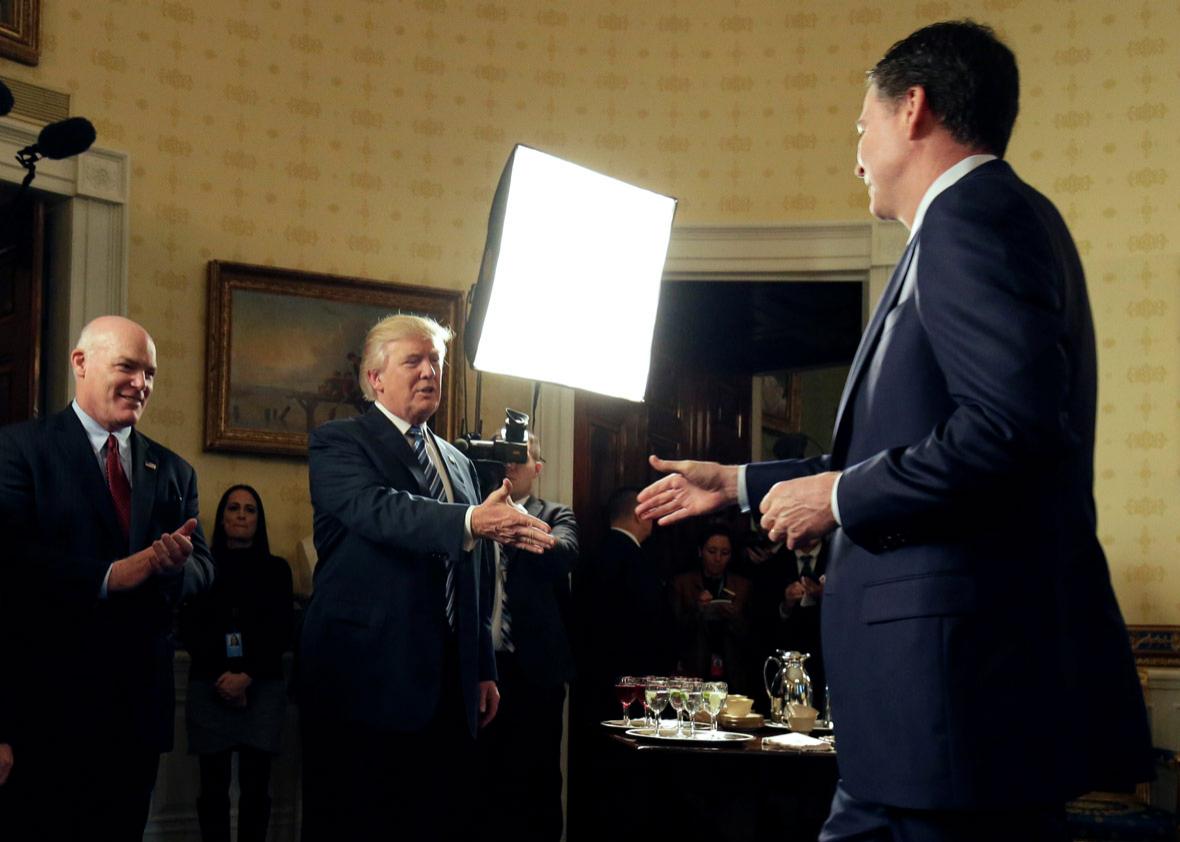 U.S. President Donald Trump greets Director of the FBI James Comey.