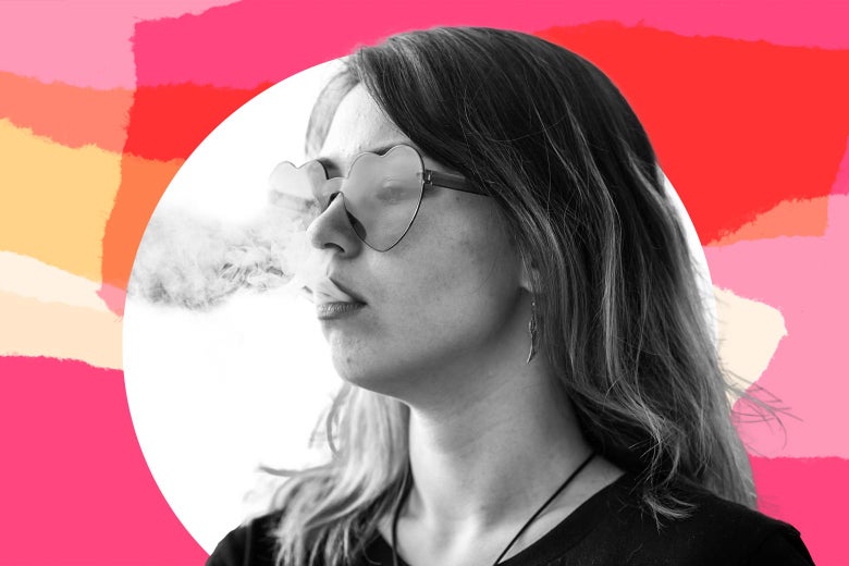 A teen girl in cool glasses smokes.