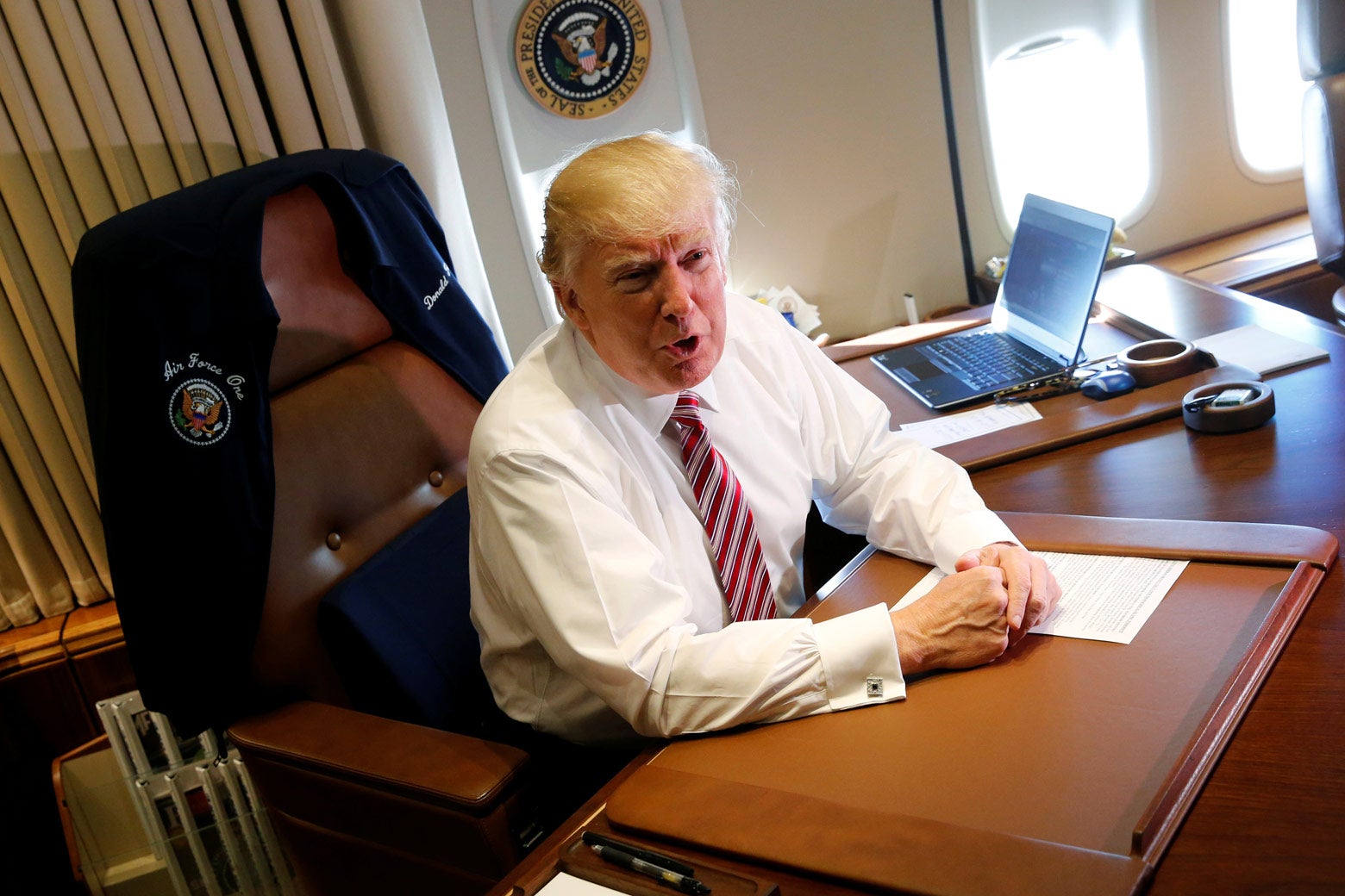President Trump aboard Air Force One on Jan. 26, 2017. He's at a desk and a computer is behind him, but he's not using it.
