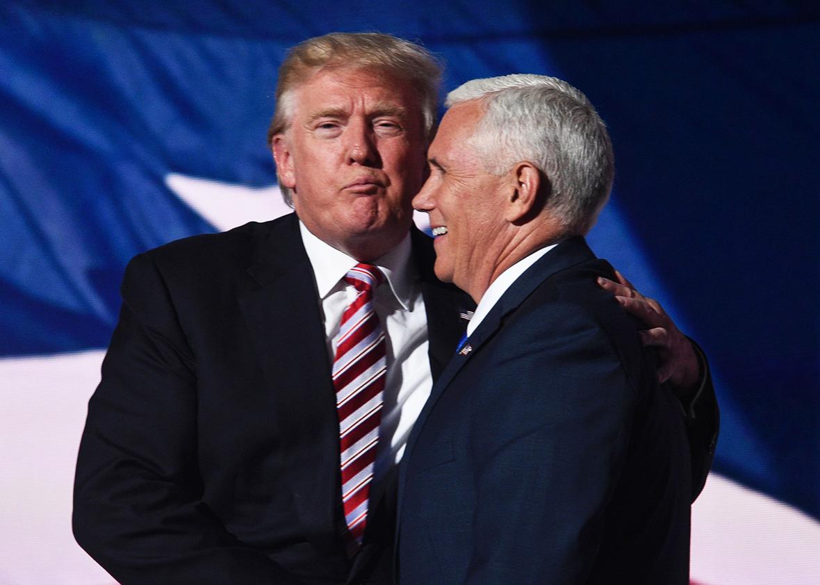 Republican presidential candidate Donald Trump shakes hands with vice presidential candidate Mike Pence at the end of the third day of the Republican National Convention at the Quicken Loans Arena in Cleveland, Ohio on July 20, 2016.
