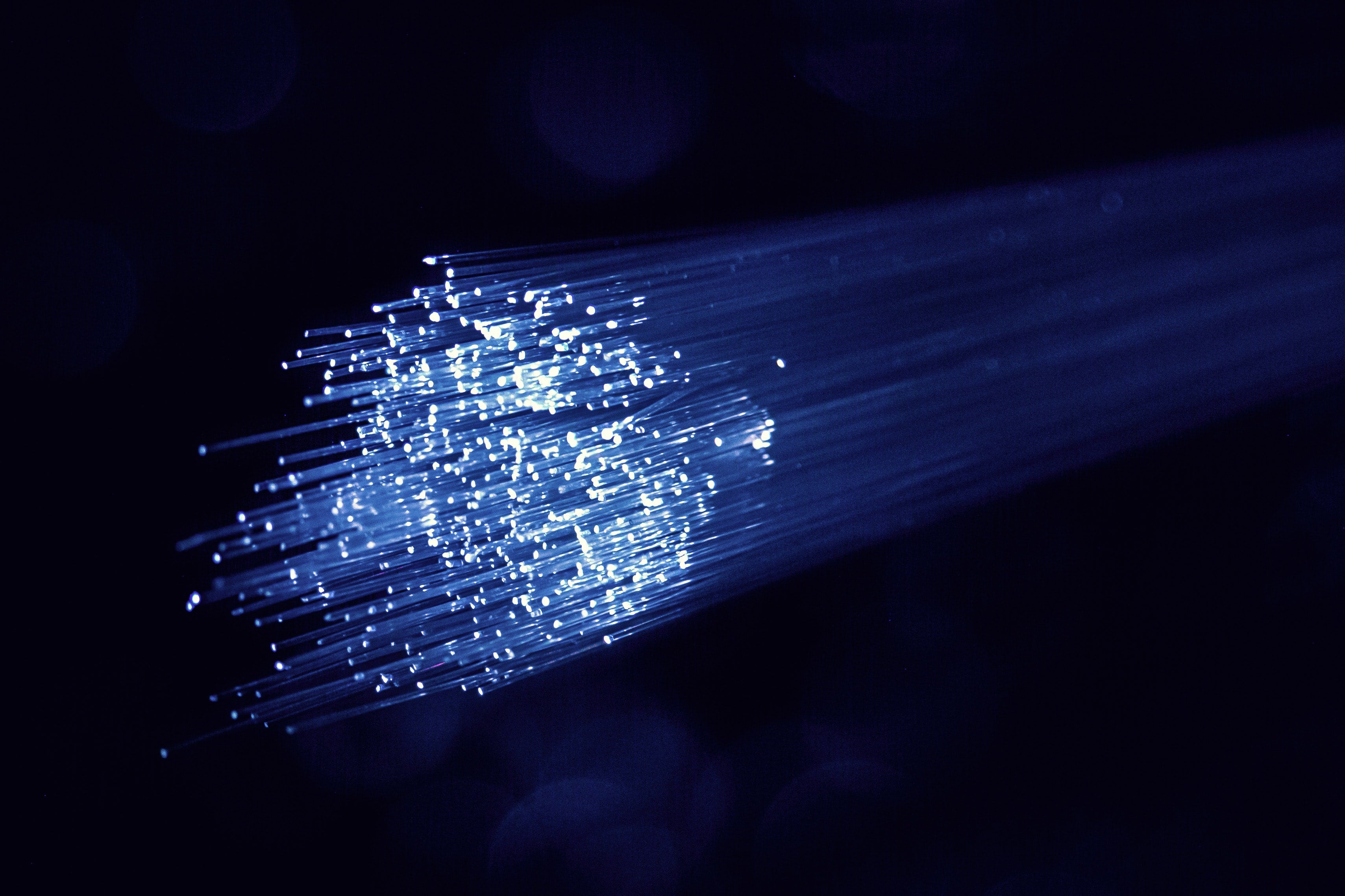 White and blue light emits from fiber optic cables.
