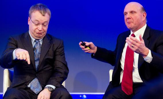 At a 2011 briefing annoucning Nokia's parternship with Microsoft, Nokia CEO Stephen Elop (left) presciently indicates which way his company's global smartphone market share is headed.